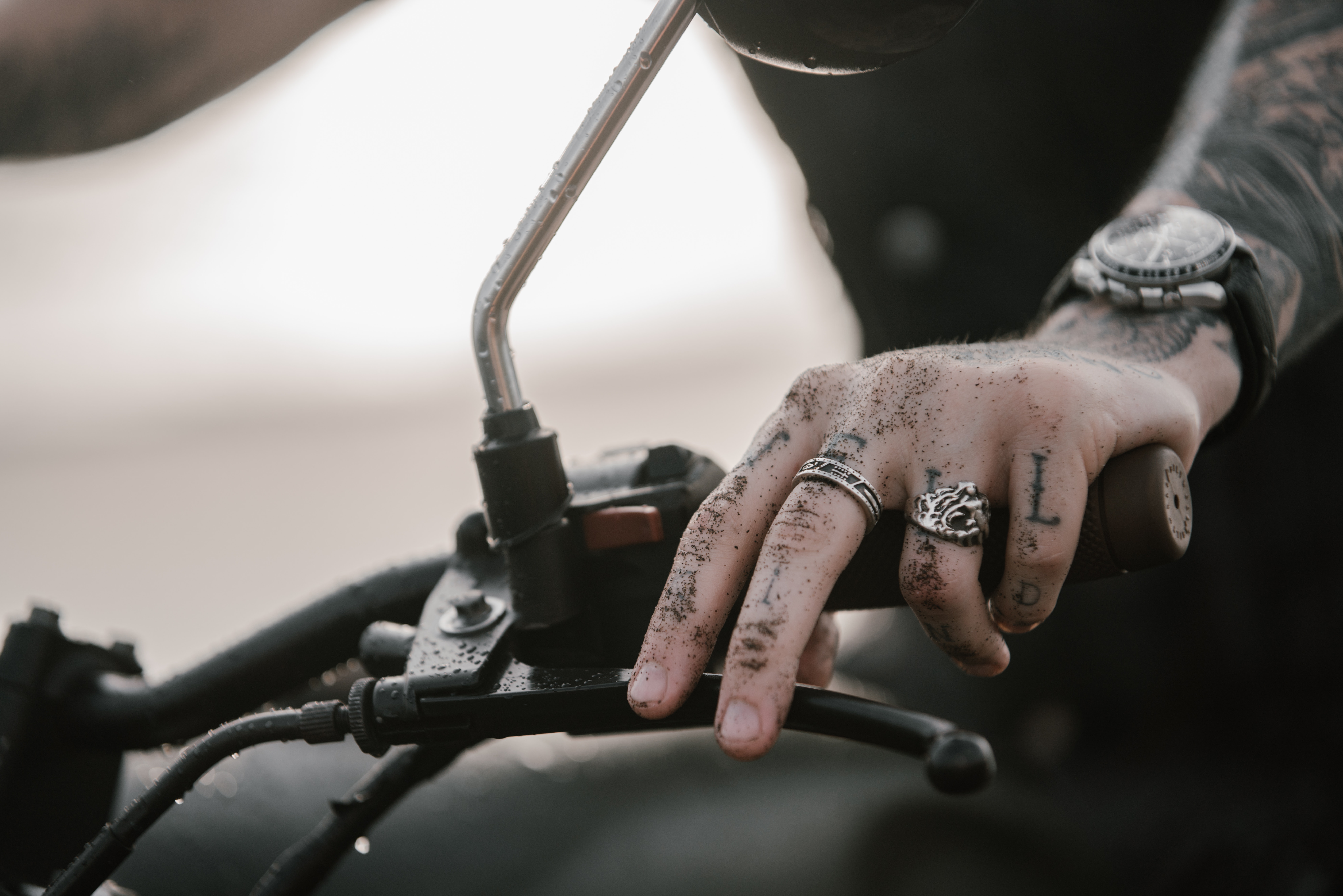 finger tattoos on a man on a motorcycle