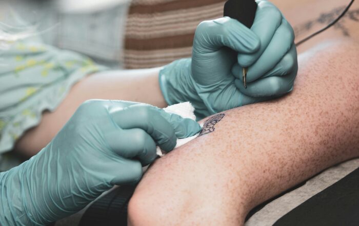 man getting toxic ink tattoo on his arm